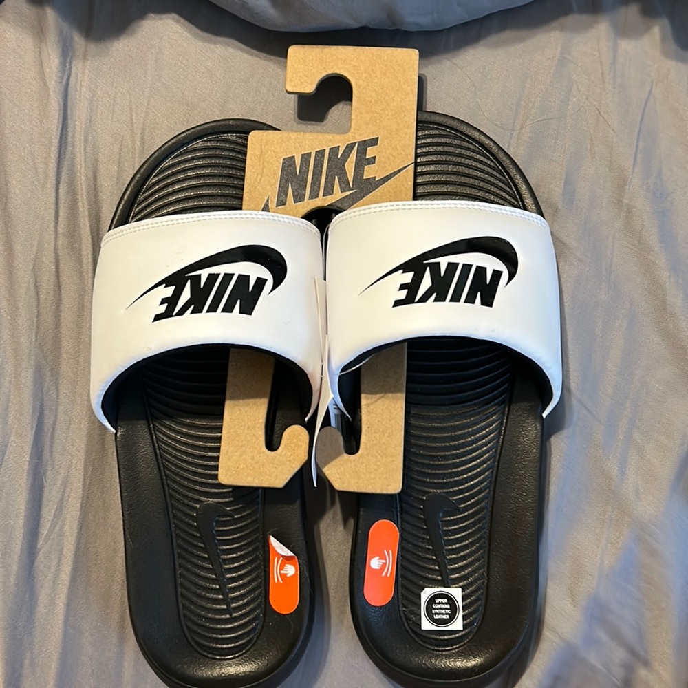 White and black Nike slides